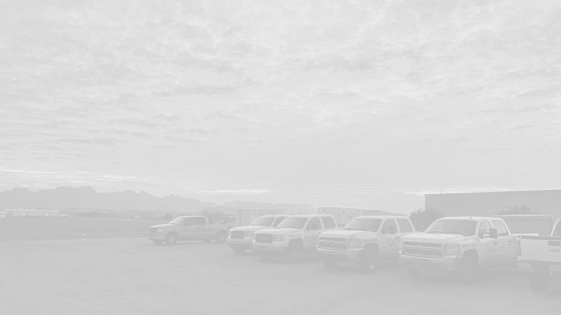 Extreme Landscaping company trucks with sunset.